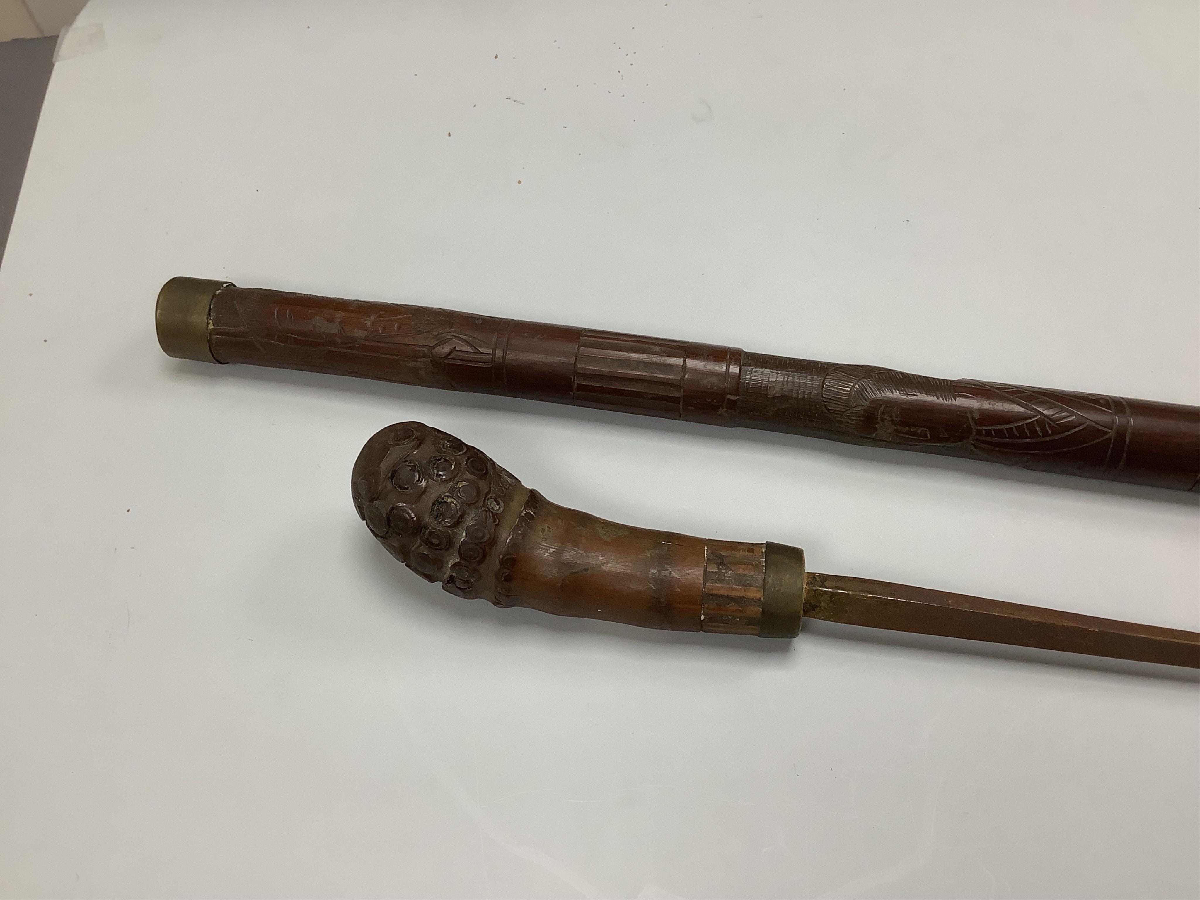 An officer’s sword, three walking sticks and an antique sword stick, longest walking stick 92cm long
